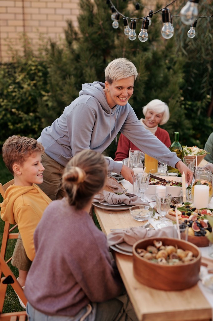 Friends and neighbors sharing a meal together outdoors